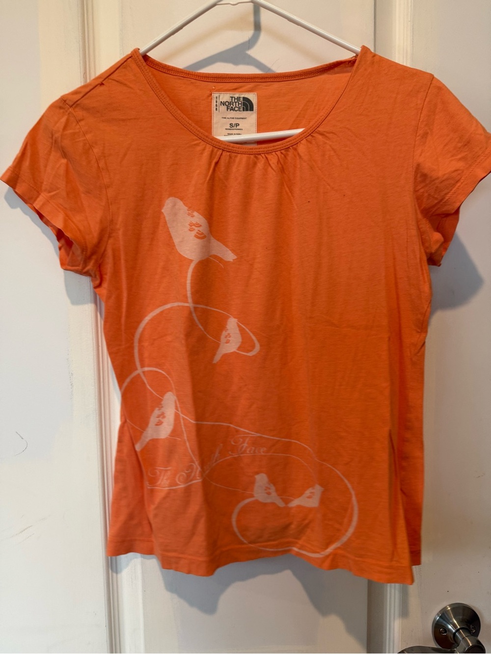 Soft orange/peachand white vintage bird print t-shirt by The North Face